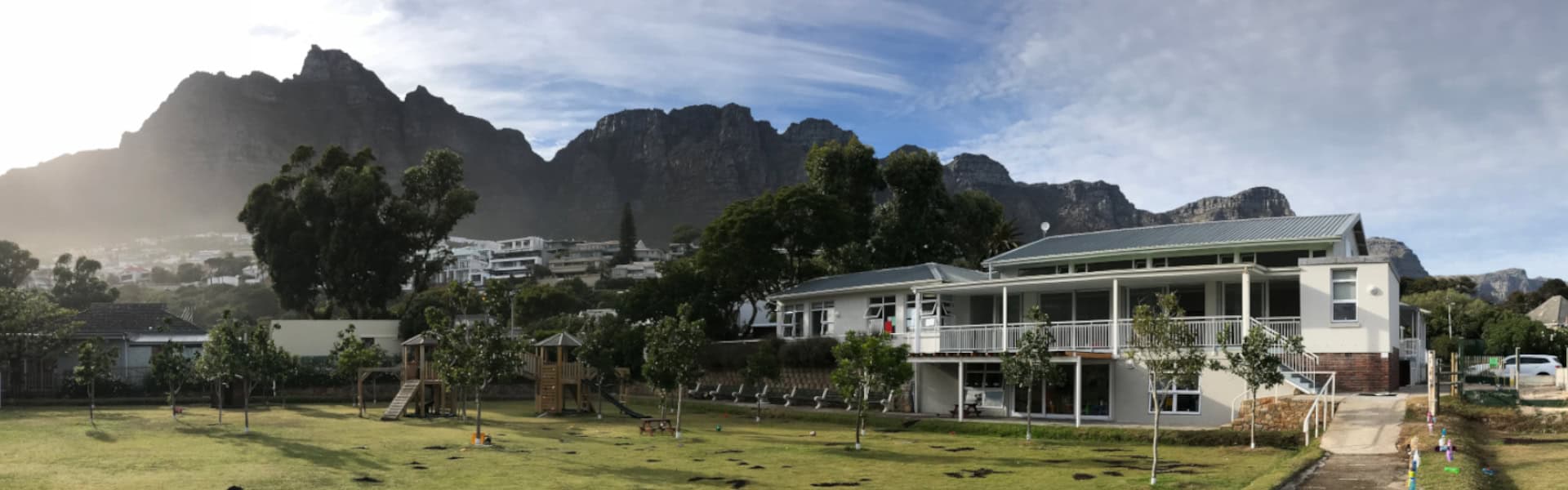 Camps Bay Primary's Preparatory Campus and field, with the Twelve Apostles mountain range behind