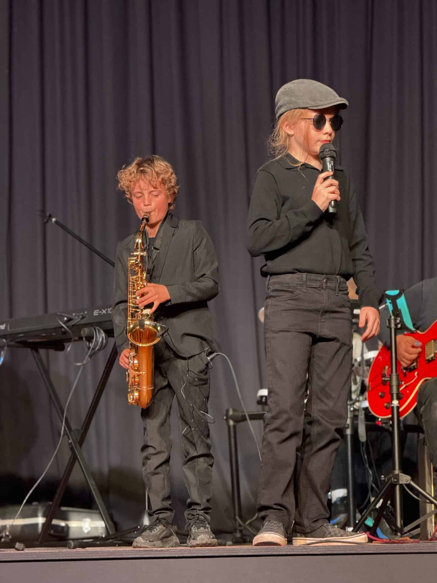 Camps Bay Primary learners performing on saxophone and vocals at a school concert