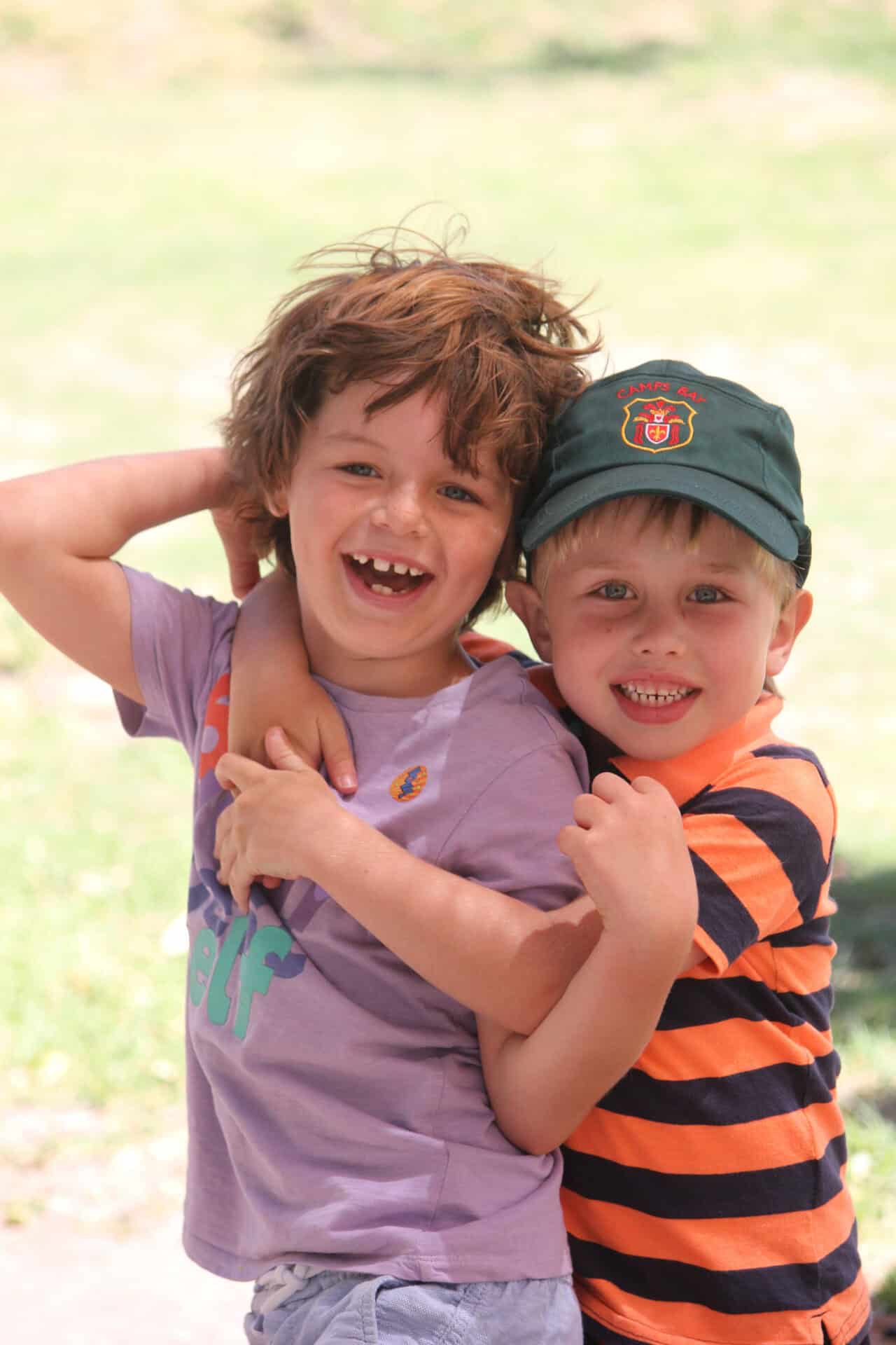 Two young Camps Bay Primary learners laughing together outdoors