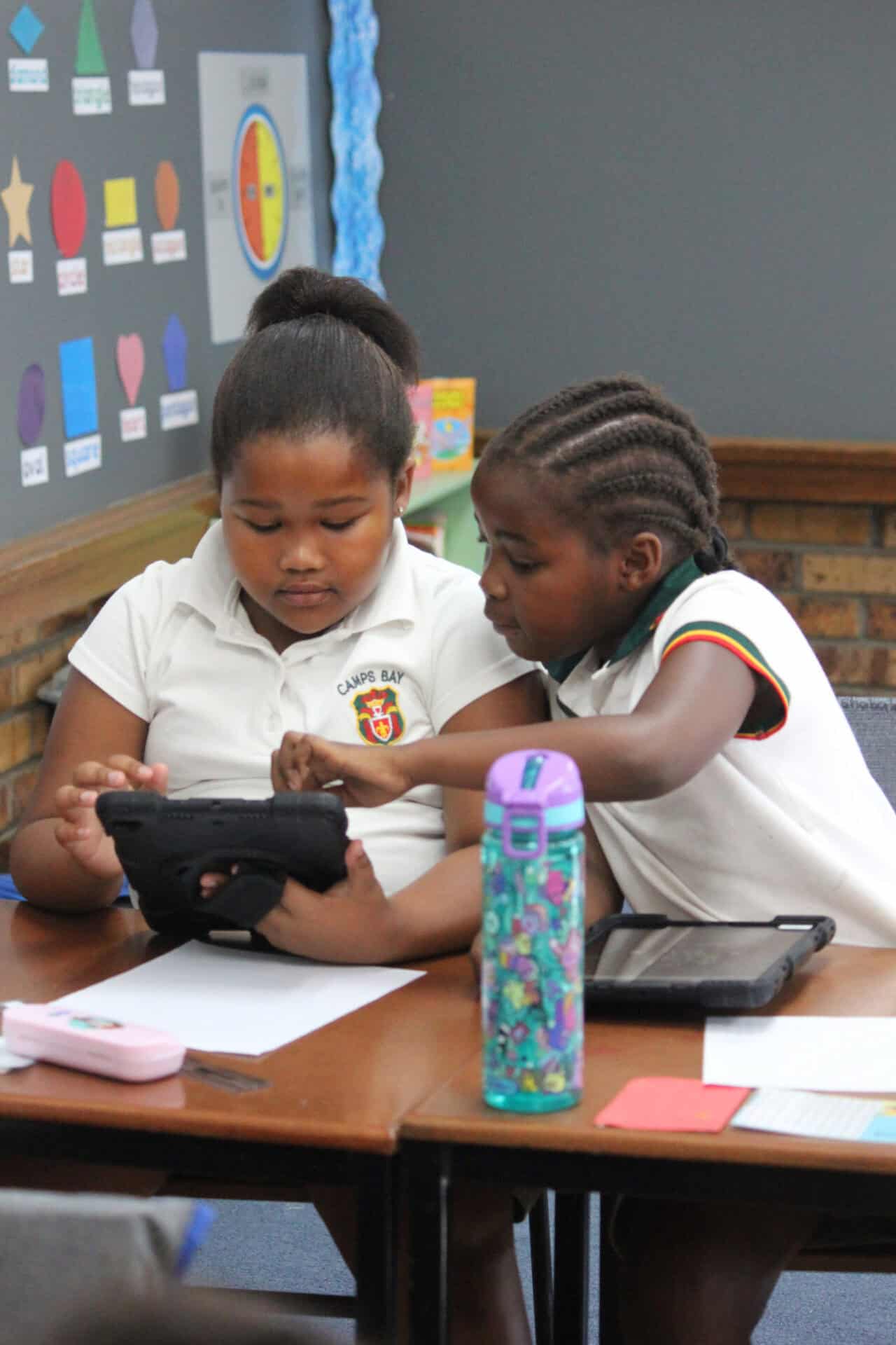 Two Camps Bay Primary learners working together on a tablet in class