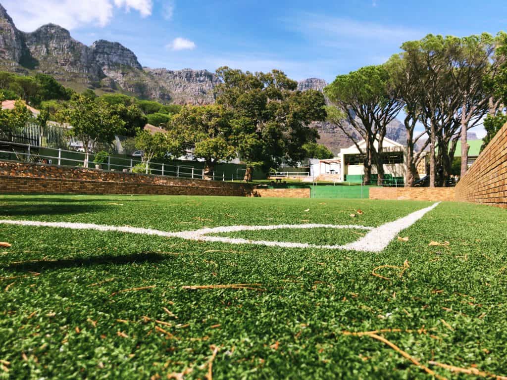 Astroturf sports field at Camps Bay Primary beneath the mountains