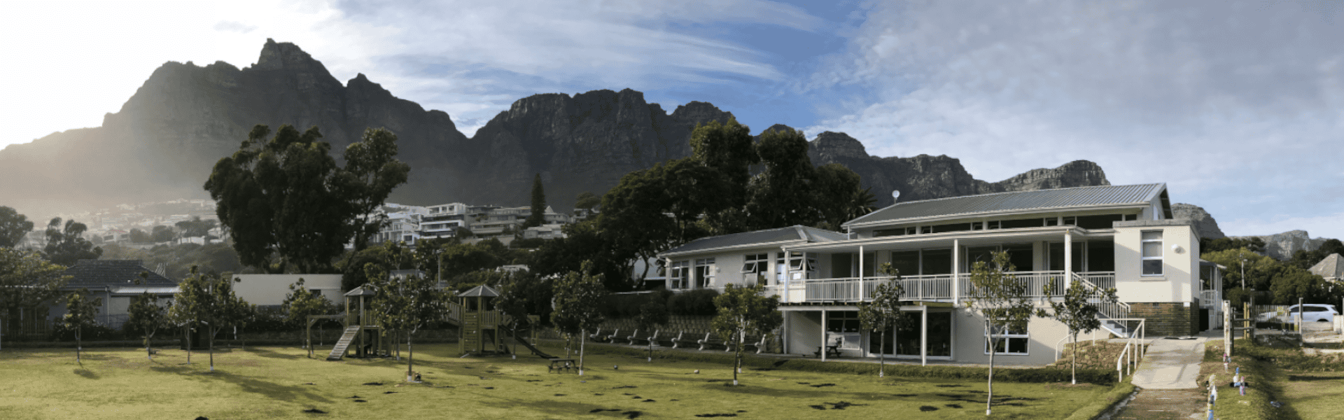 Camps Bay Primary's Preparatory Campus and field, with the Twelve Apostles mountain range behind