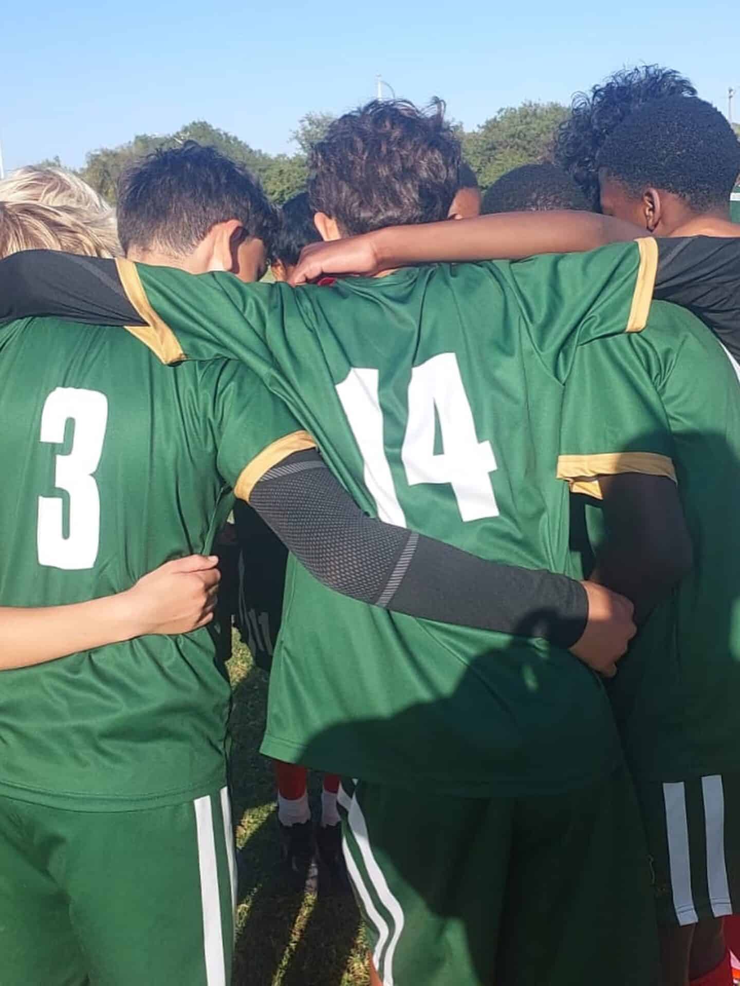 Camps Bay Primary rugby players in a team huddle